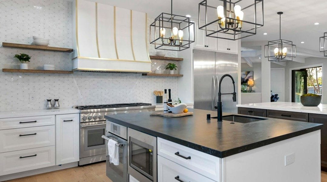 Kitchen with a sloped style wood range hood
