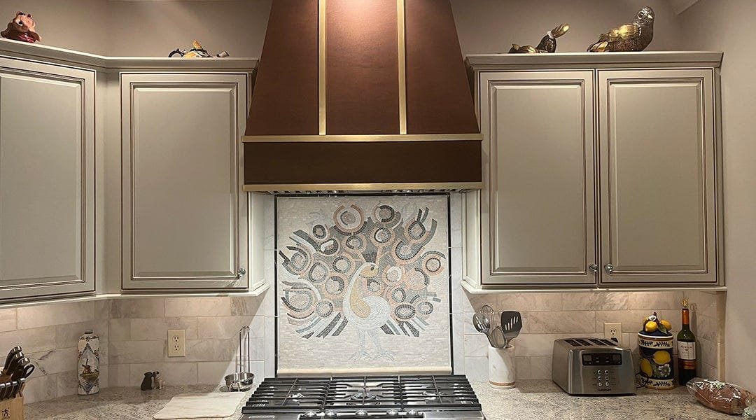 Kitchen with a tapered style wood range hood