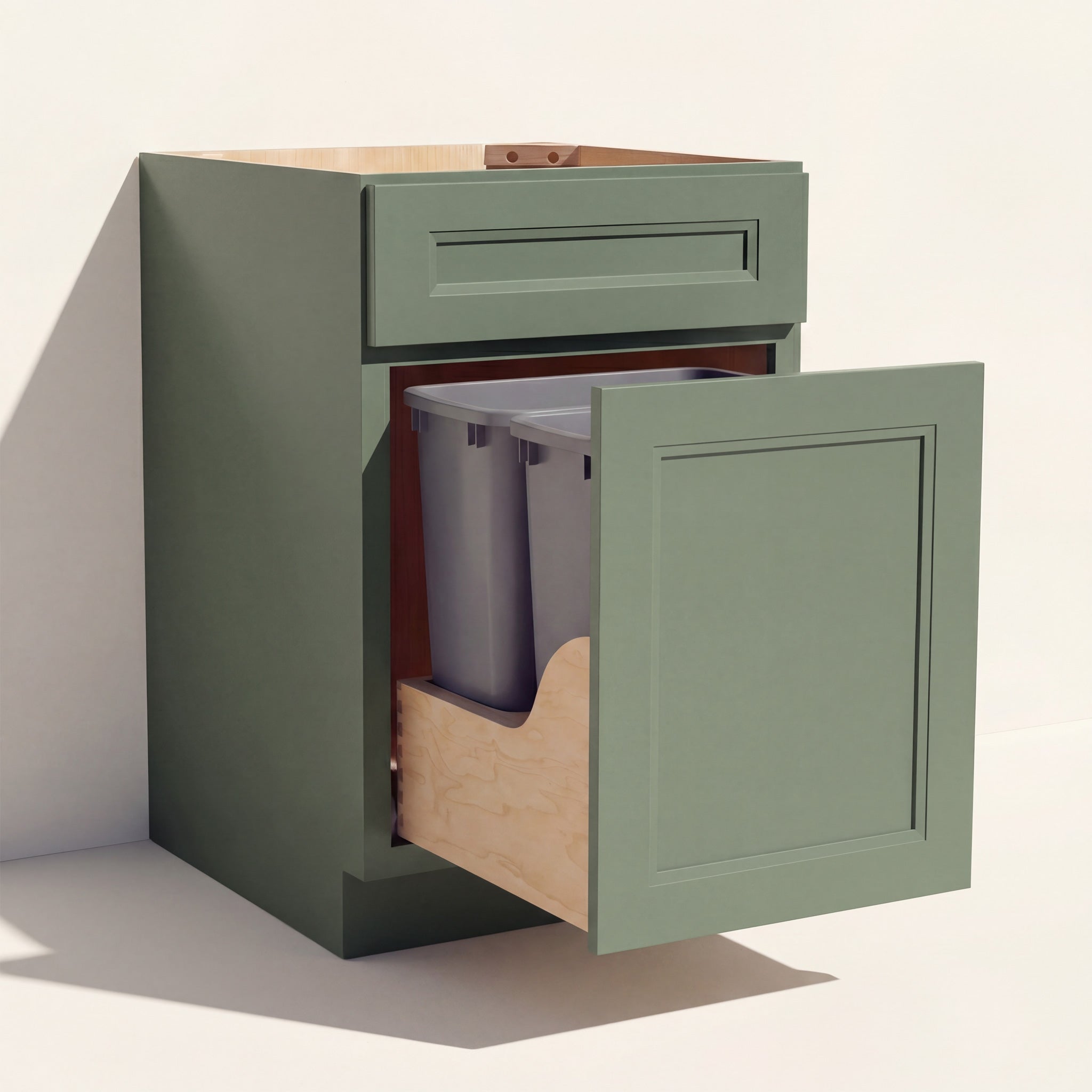 Angled view of a green Belmont beveled Shaker double trash pull-out base cabinet with 1 functional drawer and 2 waste bins.