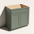 Angled view of a green 30w Belmont beveled Shaker standard base cabinet with 2 doors and 1 functional drawer.
