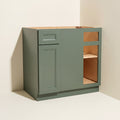 Angled view of a green Belmont beveled Shaker blind corner base cabinet with 1 door and 1 functional drawer.