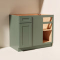 Angled view of a green Belmont beveled Shaker extended blind corner base cabinet with 1 door and 1 functional drawer.