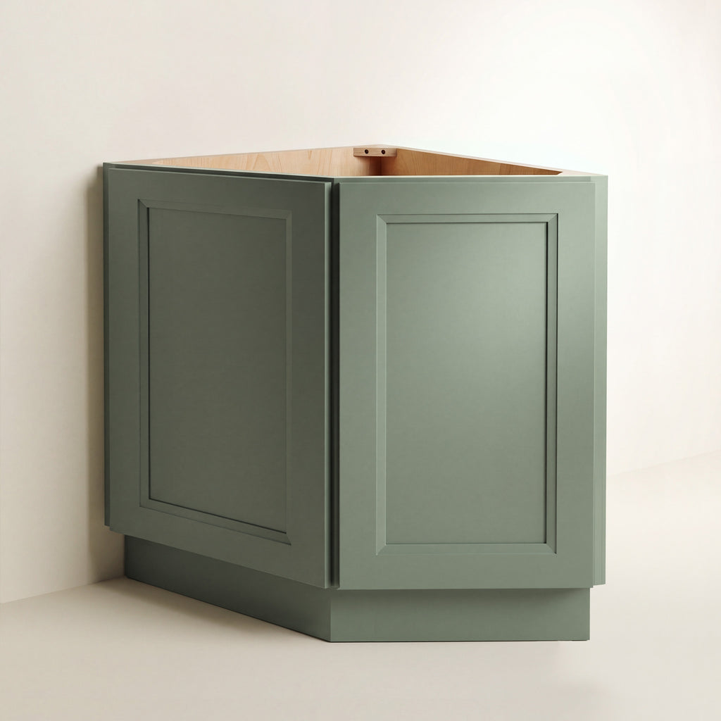 Angled view of a green Belmont beveled Shaker diagonal corner base cabinet with 2 doors.