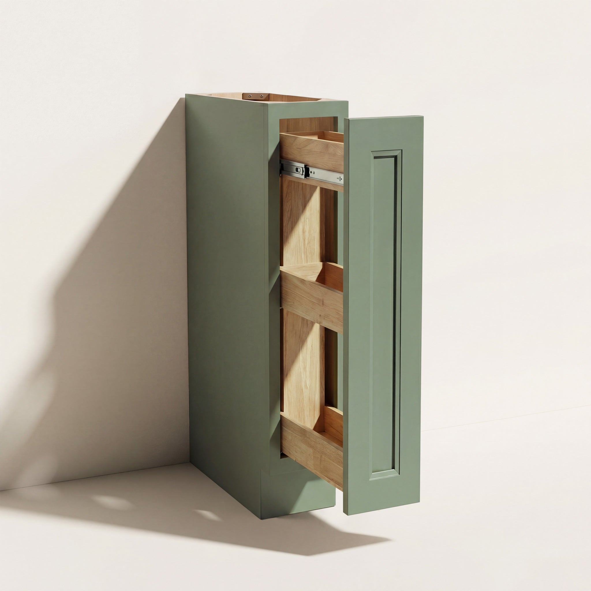 Angled view of a green Belmont beveled Shaker spice pull-out base cabinet with two tiers of storage.