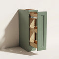 Angled view of a green Belmont beveled Shaker spice pull-out base cabinet.