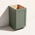 Angled view of a green Belmont beveled Shaker full-height base cabinet with 1 door and assembled construction.