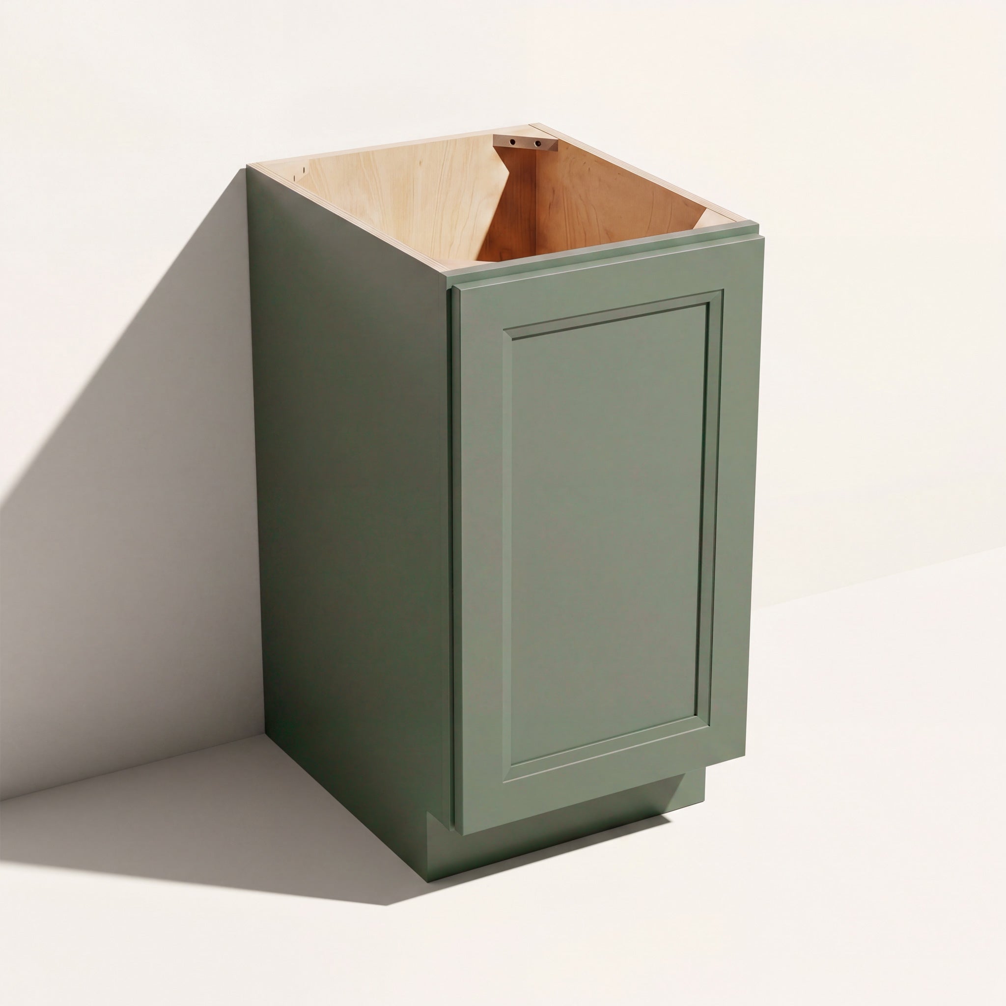 Angled view of a green Belmont beveled Shaker full-height base cabinet with 1 door and assembled construction.