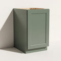 Angled view of an assembled green Belmont beveled Shaker full-height base cabinet with 1 door.
