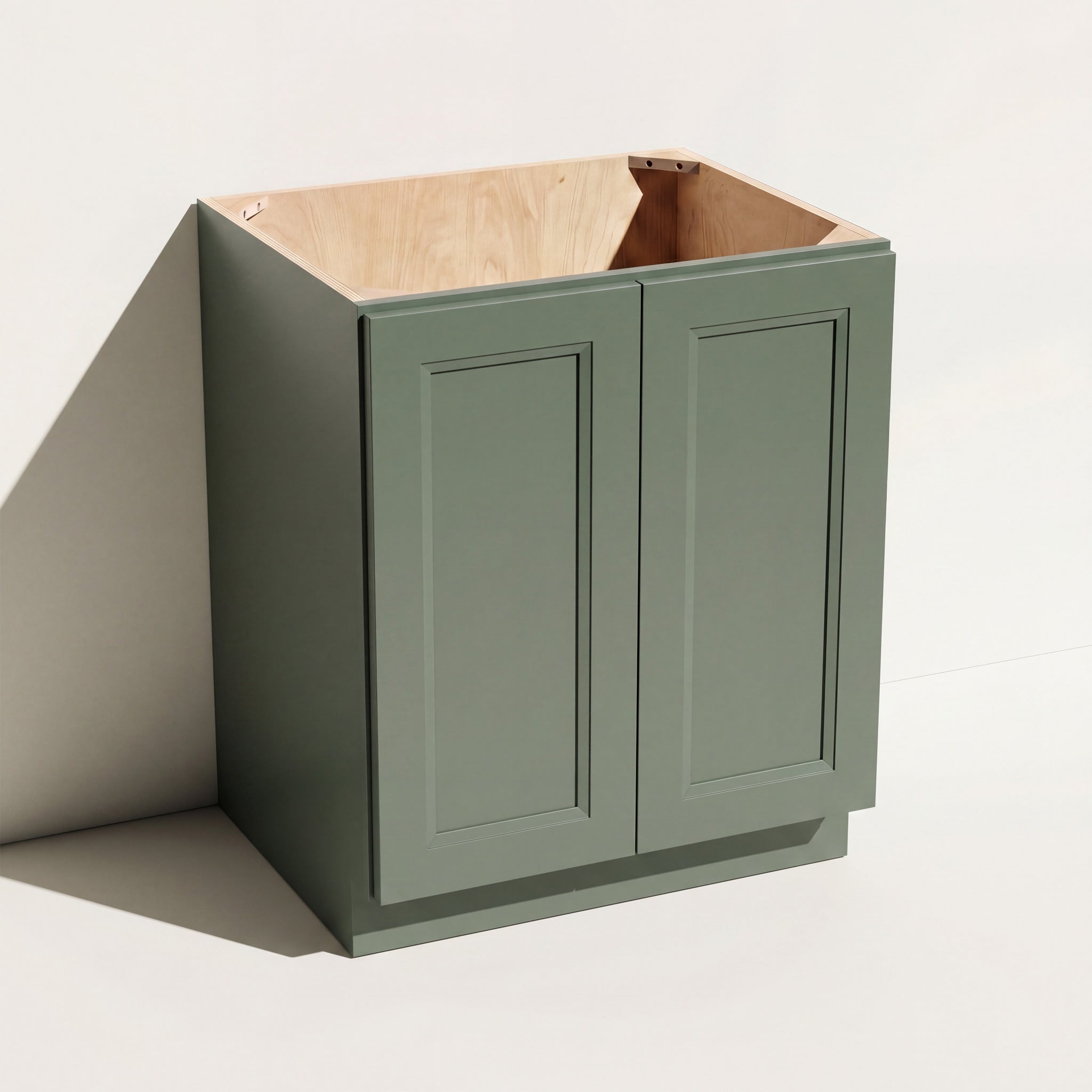 Angled view of a green Belmont Shaker angled base cabinet with two full-height doors.