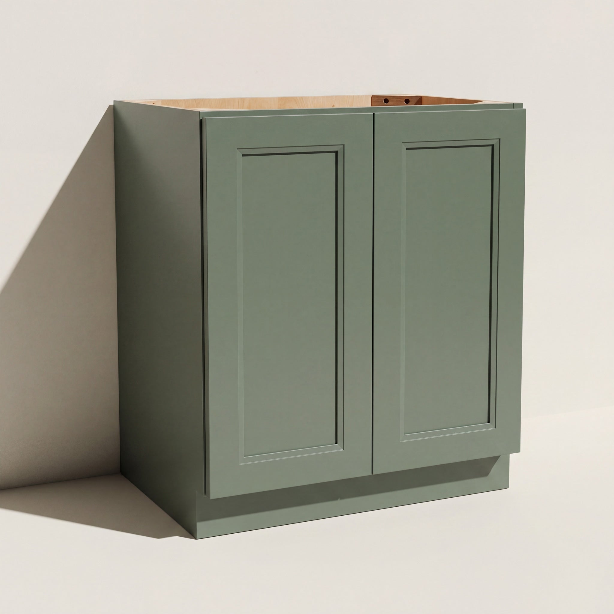 Angled view of a green 27w Belmont beveled Shaker full height double door base cabinet.