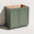 Angled view of a green Belmont beveled Shaker full height double door base cabinet with 2 doors.