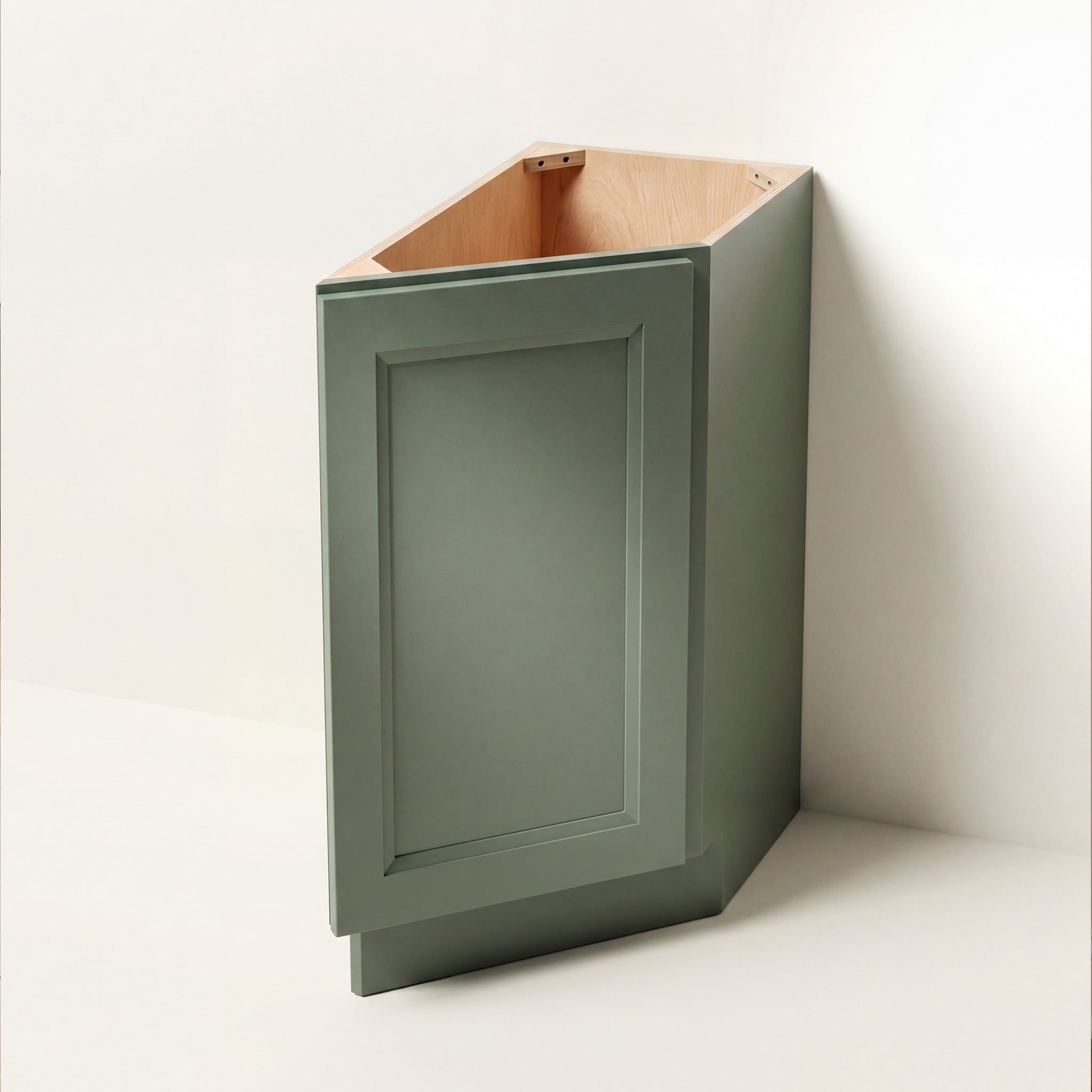 Angled view of a green Belmont beveled Shaker tray divider base cabinet with 1 door.