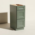Angled view of a green Belmont beveled Shaker standard narrow 3-drawer base cabinet.