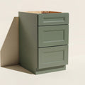 Angled view of a green 18w Belmont beveled mid-width Shaker 3-drawer base cabinet.