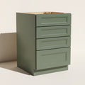Angled view of a green 21w Belmont Shaker 4-drawer base cabinet.
