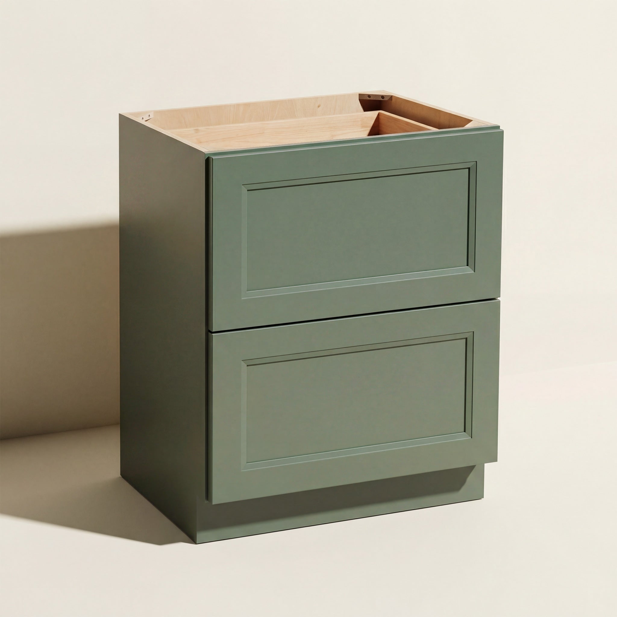 Angled view of a green Belmont beveled Shaker base cabinet with 2 functional drawers.