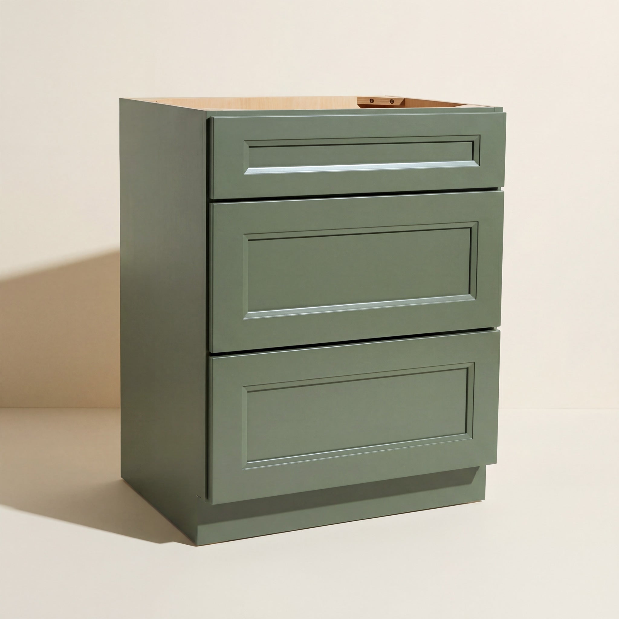 Angled view of a green 24w Belmont Shaker 3-drawer base cabinet.