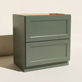 Angled view of a green Belmont beveled Shaker wide 2-drawer base cabinet.