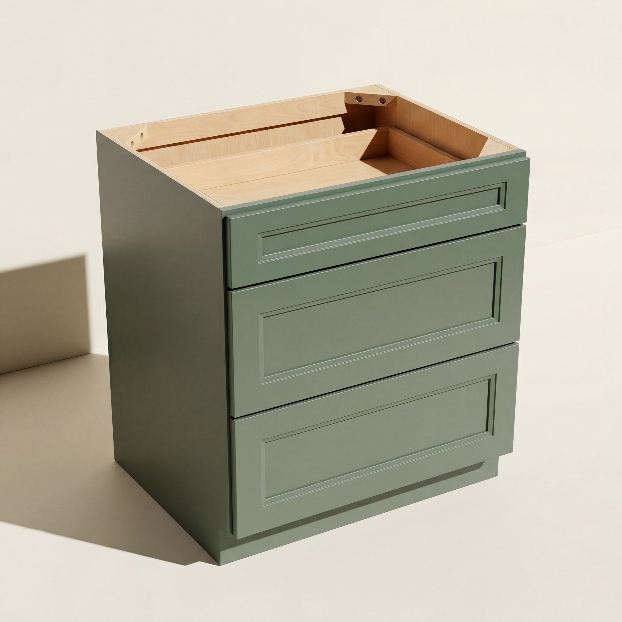 Angled view of a green 30w Belmont Shaker 3-drawer base cabinet.