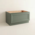 Angled view of a green Belmont Shaker bench seat base cabinet with 1 functional drawer.