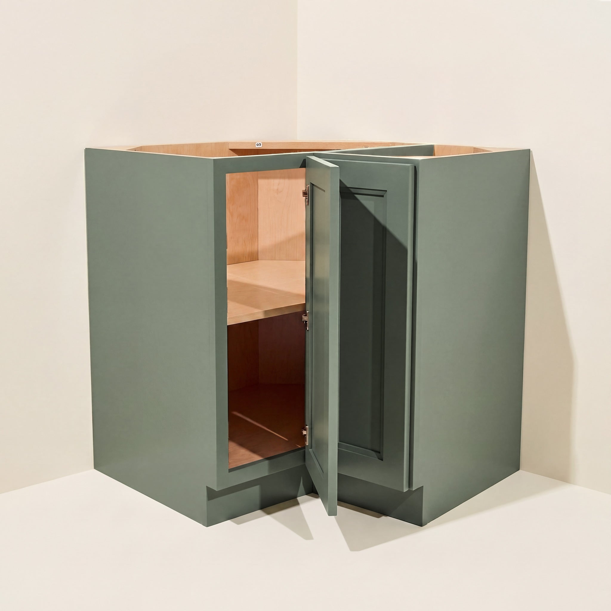 Angled view of a green Belmont beveled Shaker easy reach corner base cabinet with 1 bi-fold door.