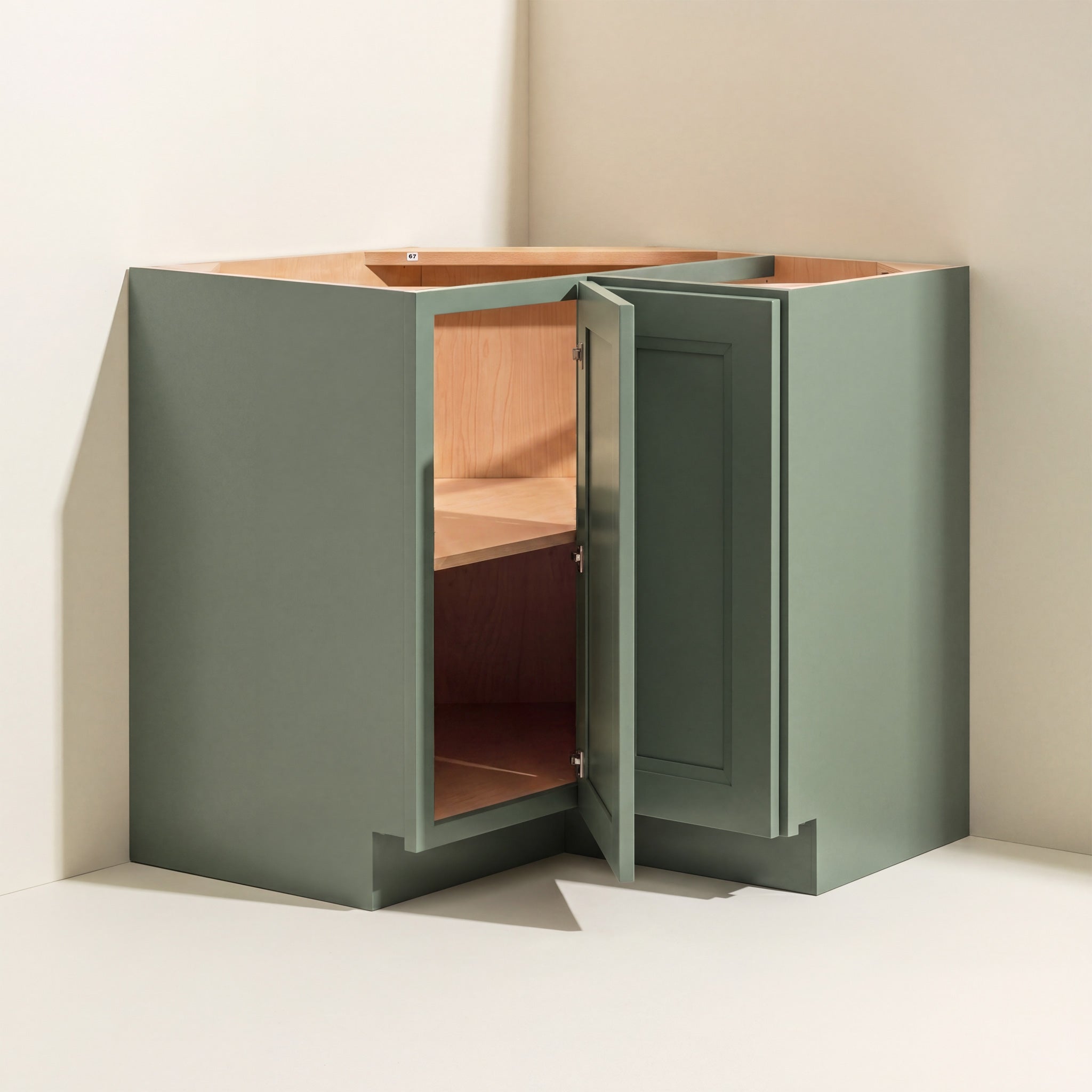Angled view of a green Belmont beveled Shaker easy-reach corner base cabinet with 1 bi-fold door.
