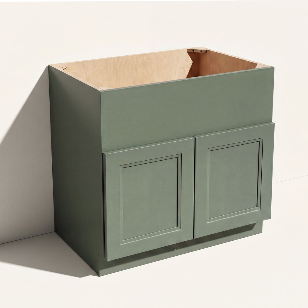 Angled view of a green 36w Belmont beveled Shaker farm sink base with 2 doors and panel to be cut to fit sink during install.