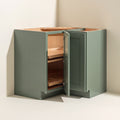 Angled view of a green Belmont beveled Shaker assembled corner lazy Susan base cabinet with 1 bi-fold door.