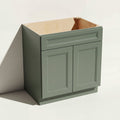 Angled view of a green 27w Belmont beveled Shaker sink base cabinet with 2 doors and 1 false drawer.