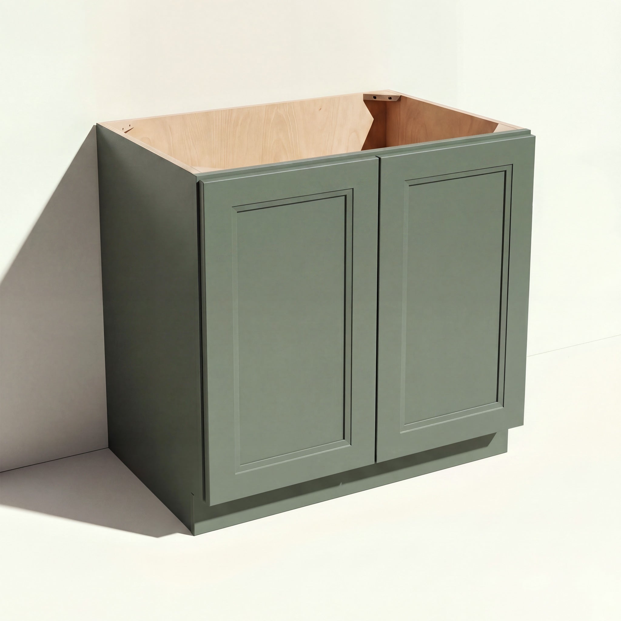 Angled view of a green 33w Belmont beveled Shaker sink base cabinet with 2 doors and 1 false drawer.