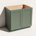 Angled view of a green 36w Belmont beveled Shaker sink base cabinet with 2 doors and 1 false drawer.