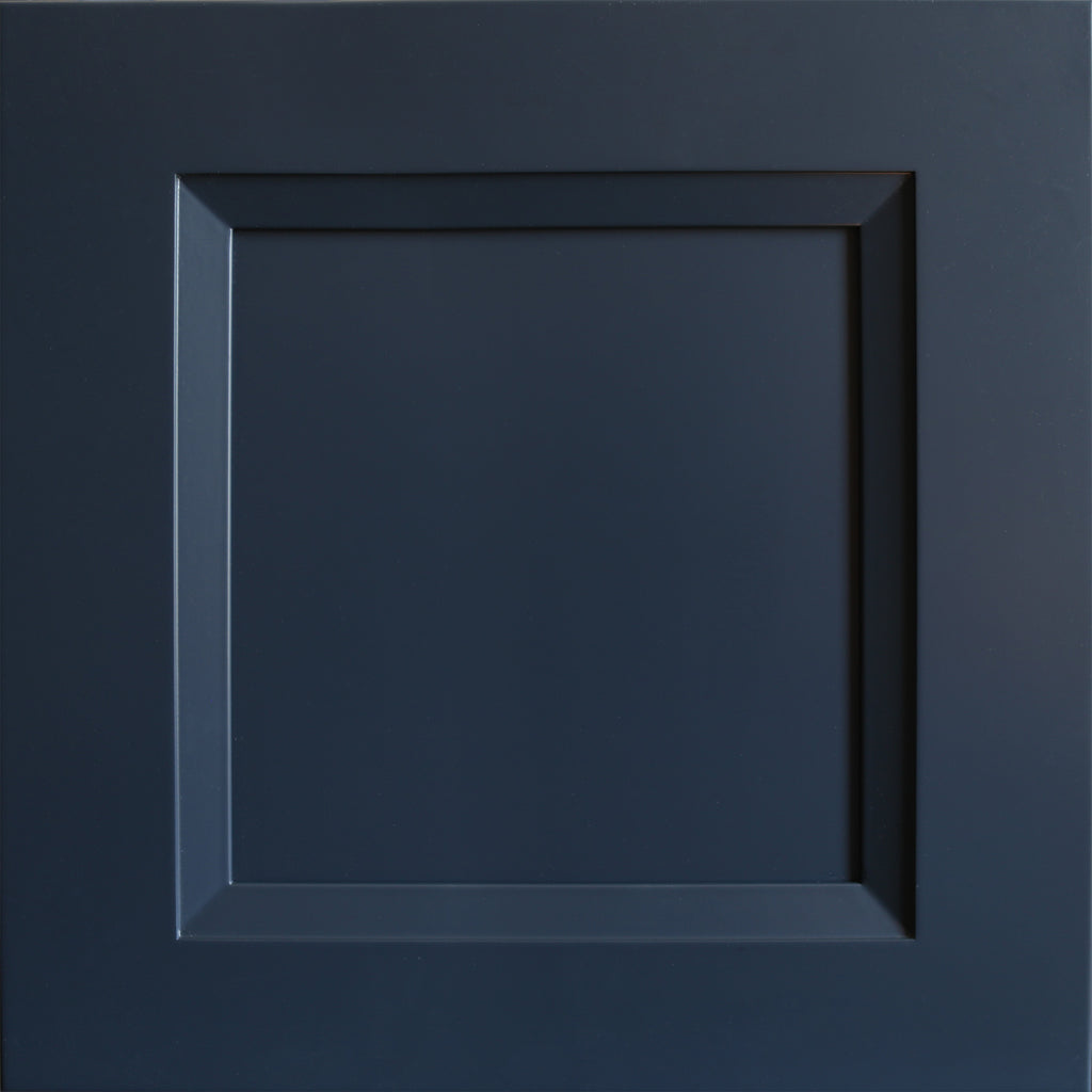 Close up view of a dark blue Belmont shaker cabinet door with a beveled edge that transitions to a recessed panel.