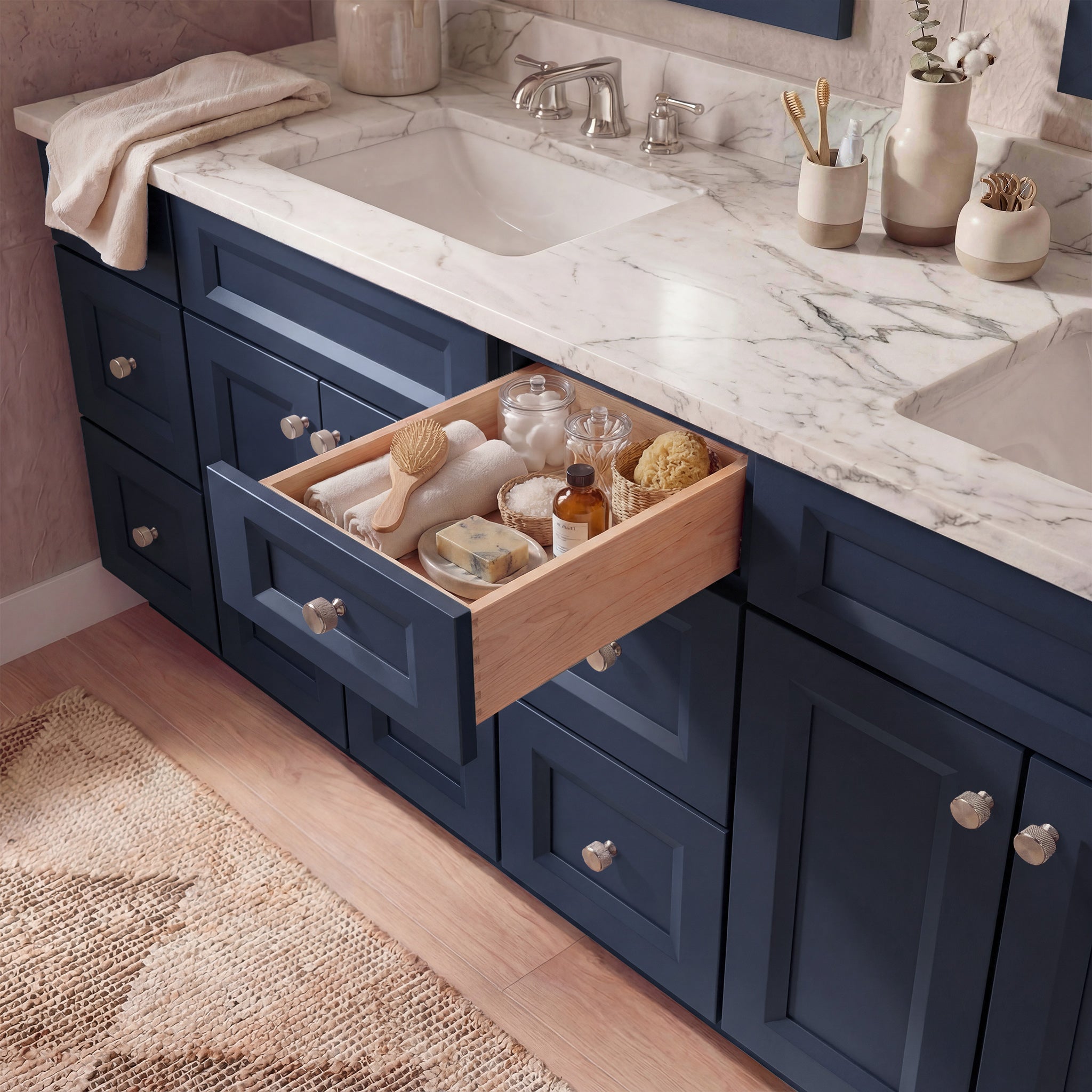 Top-down angled view of a blue Belmont shaker vanity with an open drawer, lived-in feel, and Mont Blanc quartzite counter.