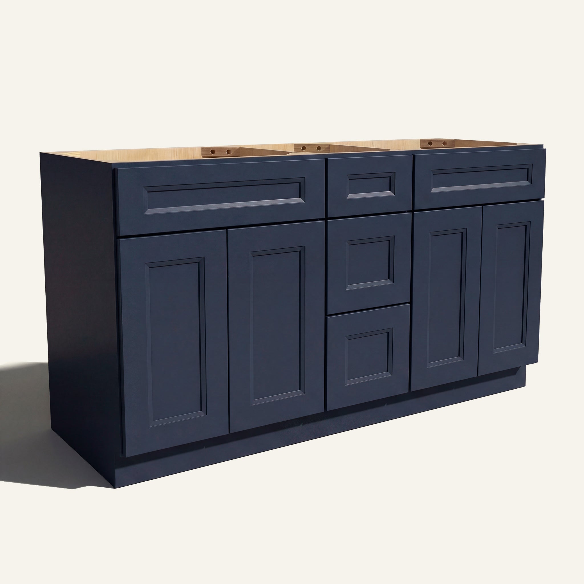 Angled view of a blue Belmont beveled Shaker double sink vanity base with 4 doors, 3 drawers, and 2 false drawer fronts.
