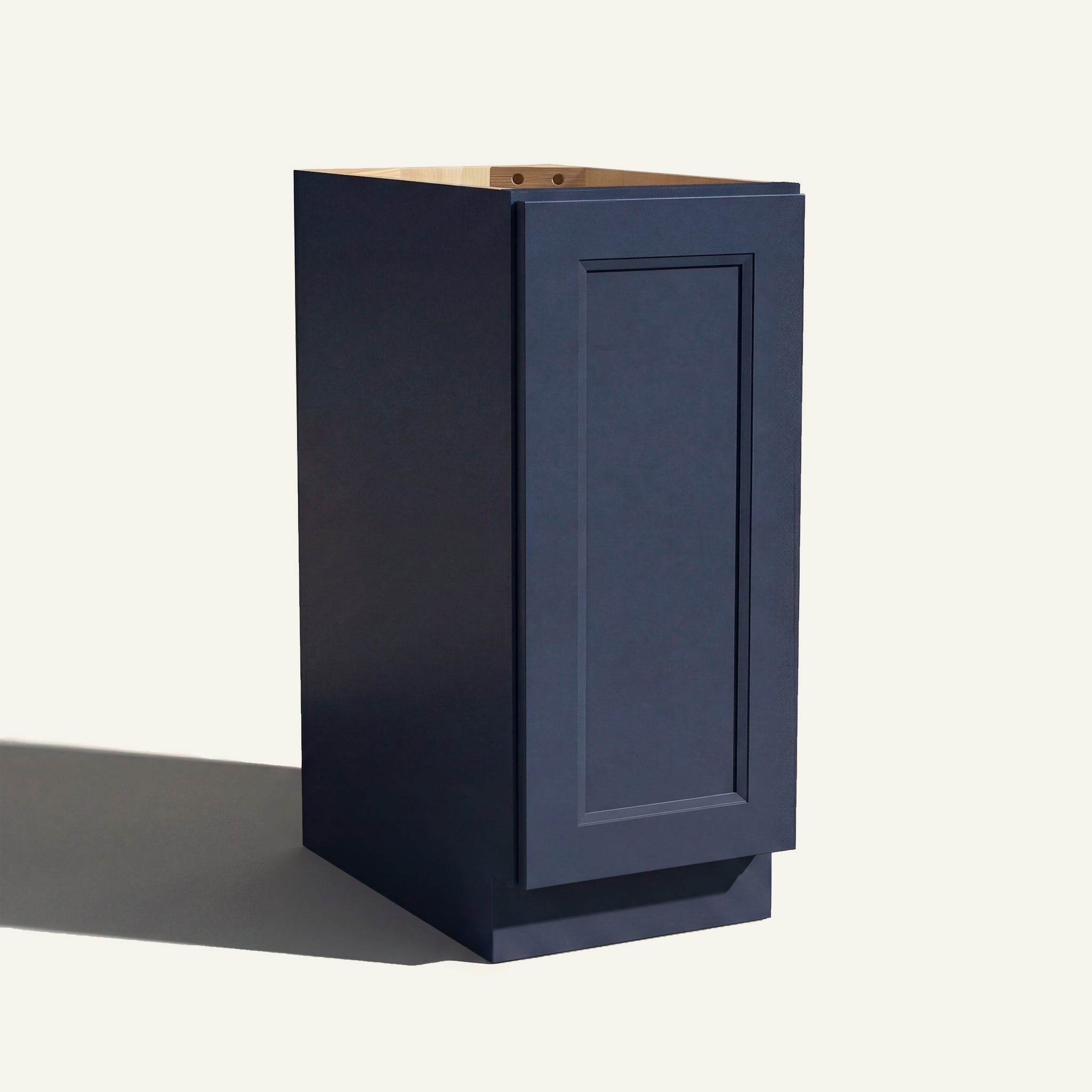 Angled view of a blue Belmont beveled Shaker base cabinet with 1 full-height door.