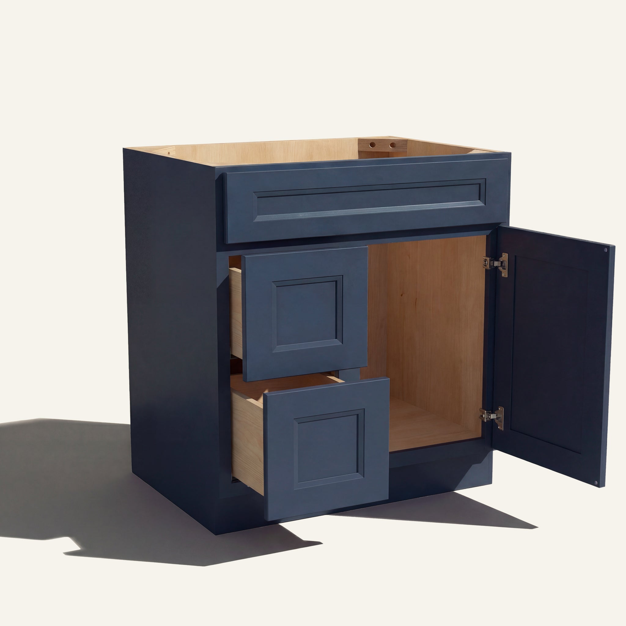 Open view of a blue Belmont beveled shaker single sink vanity with 1 door and 2 drawers on the left.