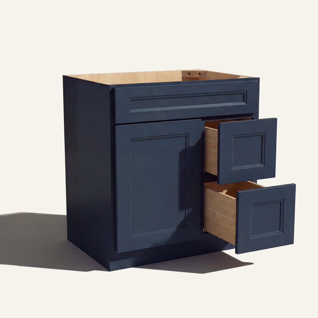 Warm bathroom scene of a blue Belmont shaker single sink vanity with 1 door, 2 drawers right, and 1 false front.