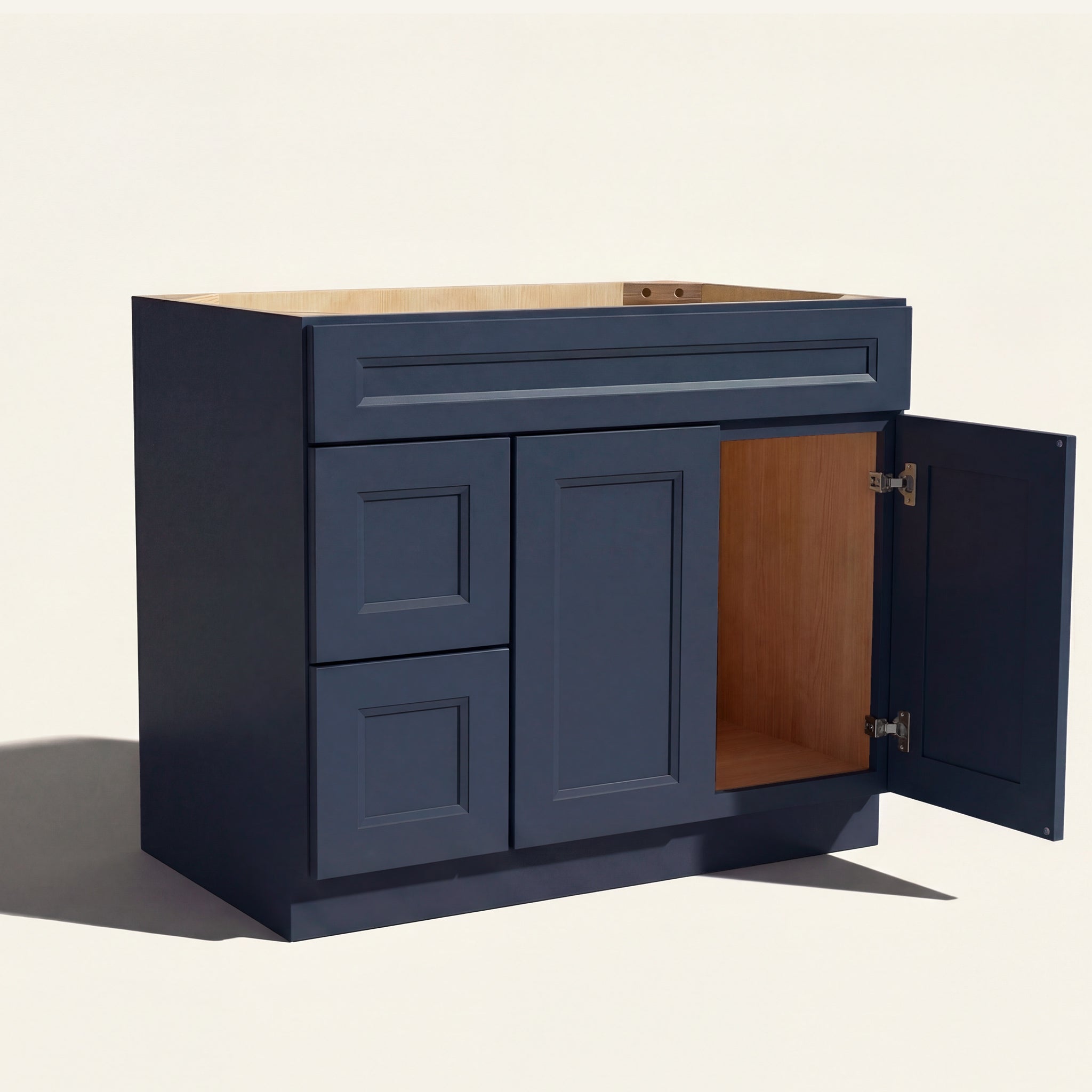 Open right door view of a blue Belmont beveled shaker single sink vanity featuring two doors and 2 left-side stacked drawers.