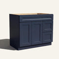 Angled view of blue Belmont beveled Shaker single sink vanity, 2 doors, 2 drawers right, and 1 false drawer front.