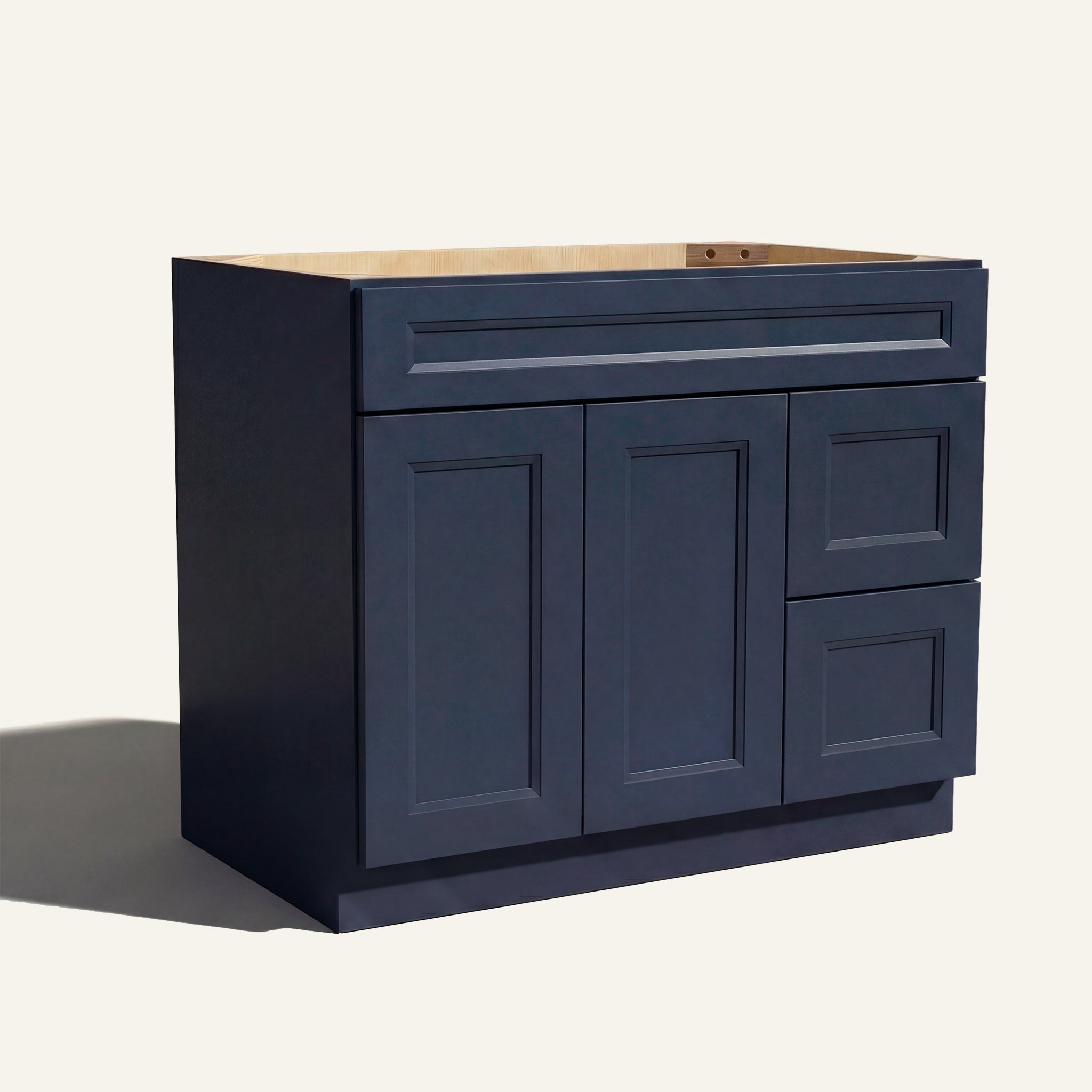 Angled view of blue Belmont beveled Shaker single sink vanity, 2 doors, 2 drawers right, and 1 false drawer front.