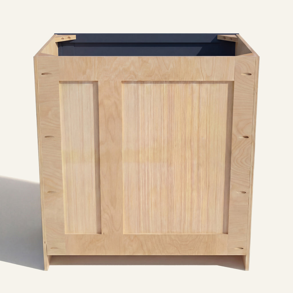 Rear view of a blue Belmont vanity with offset plumbing supports, pocket screw holes, and builder grade plywood construction.