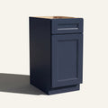 Angled view of a blue Belmont beveled Shaker vanity base cabinet with 1 door and 1 drawer.