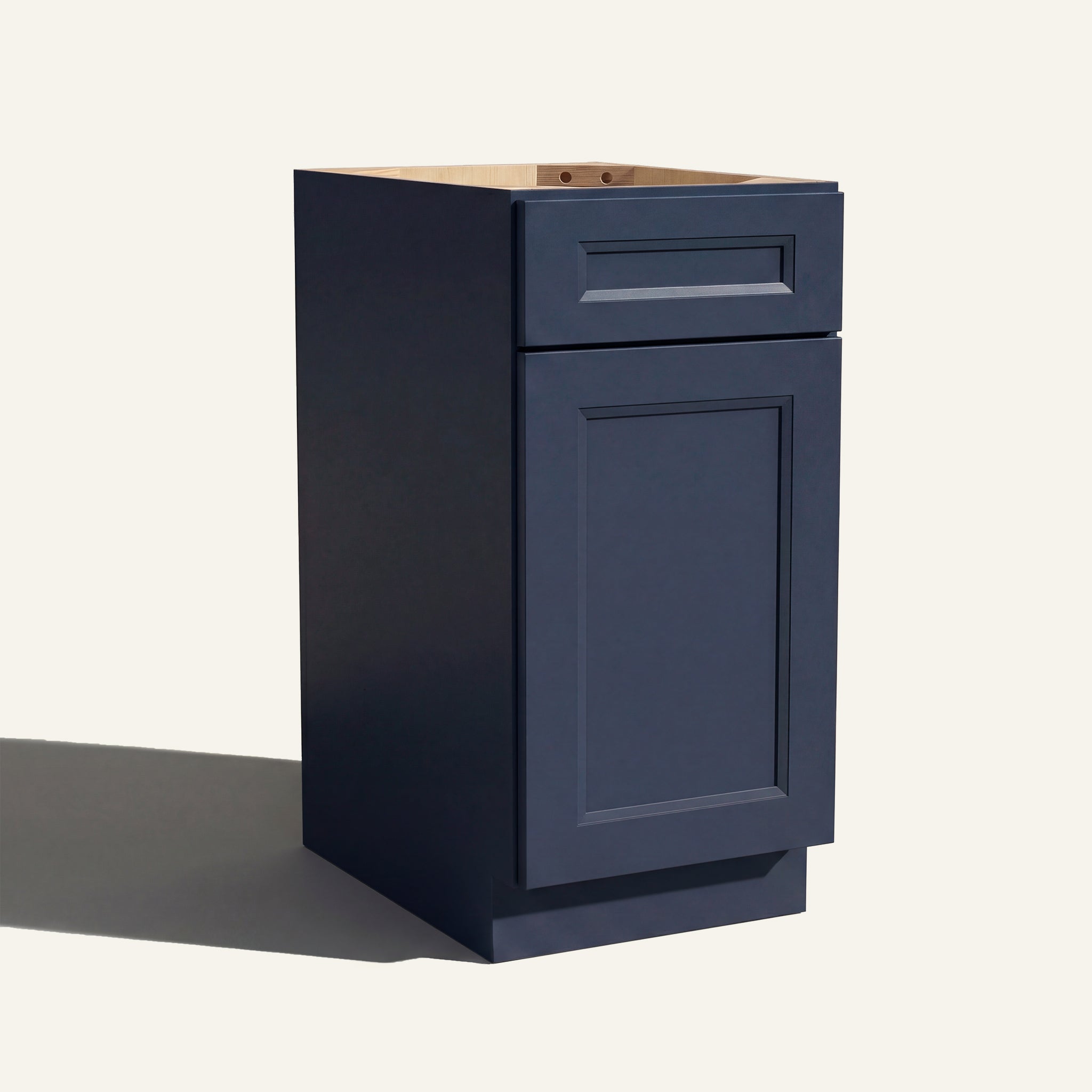 Angled view of a blue Belmont beveled Shaker vanity base cabinet with 1 door and 1 drawer.