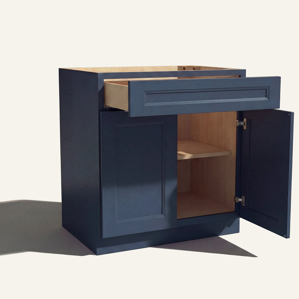 Angle view of a blue Belmont beveled shaker base cabinet with 2 doors and 1 open drawer. Right door is open, showing a shelf.