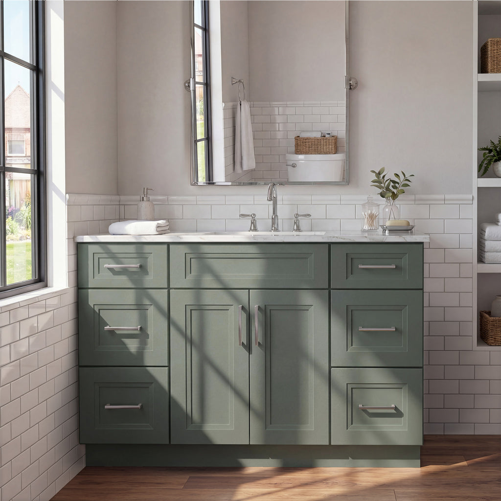 Front view of a green Belmont shaker vanity with 2 doors, 6 drawers, and 1 false drawer front in a warm contemporary bathroom.
