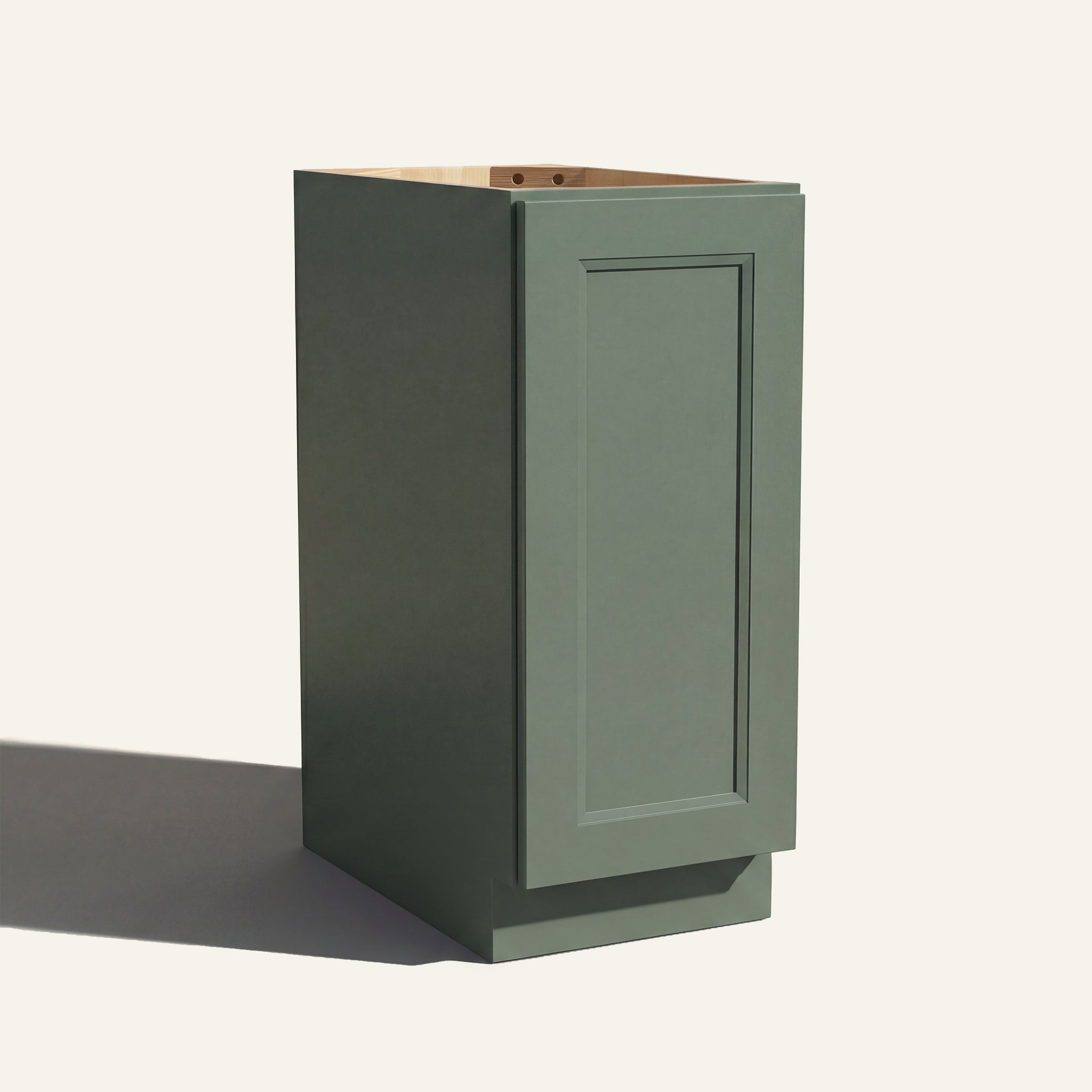 Angled view of a green Belmont beveled Shaker base cabinet with 1 full-height door.