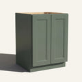 Angled view of a green Belmont beveled Shaker base cabinet with 2 full height doors.