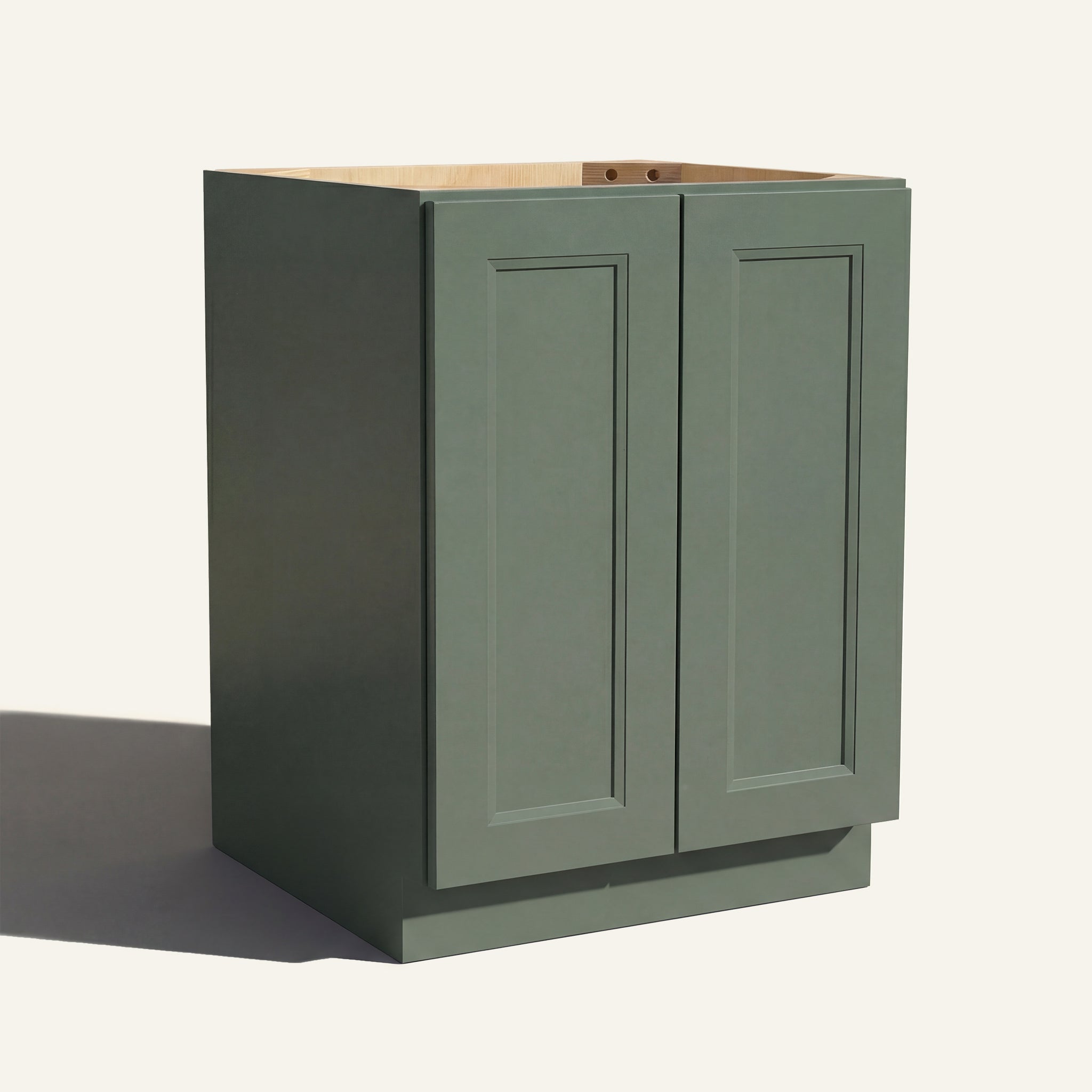 Angled view of a green Belmont beveled Shaker base cabinet with 2 full height doors.