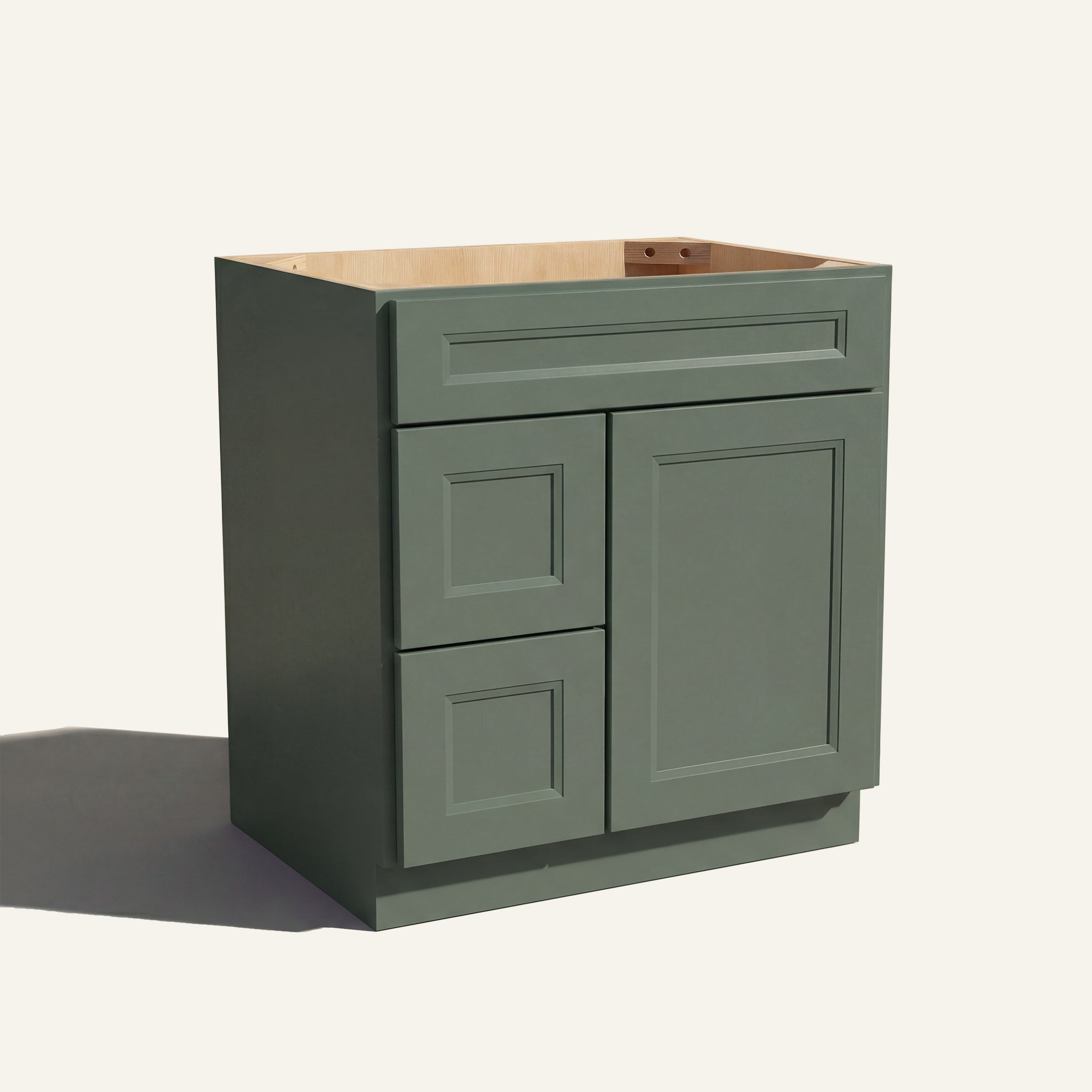 Angled view of a green Belmont beveled shaker single sink vanity with a right-side door and two left-side drawers.