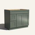 Angled view of a green Belmont beveled shaker single sink vanity featuring two doors and a left-side drawer bank.